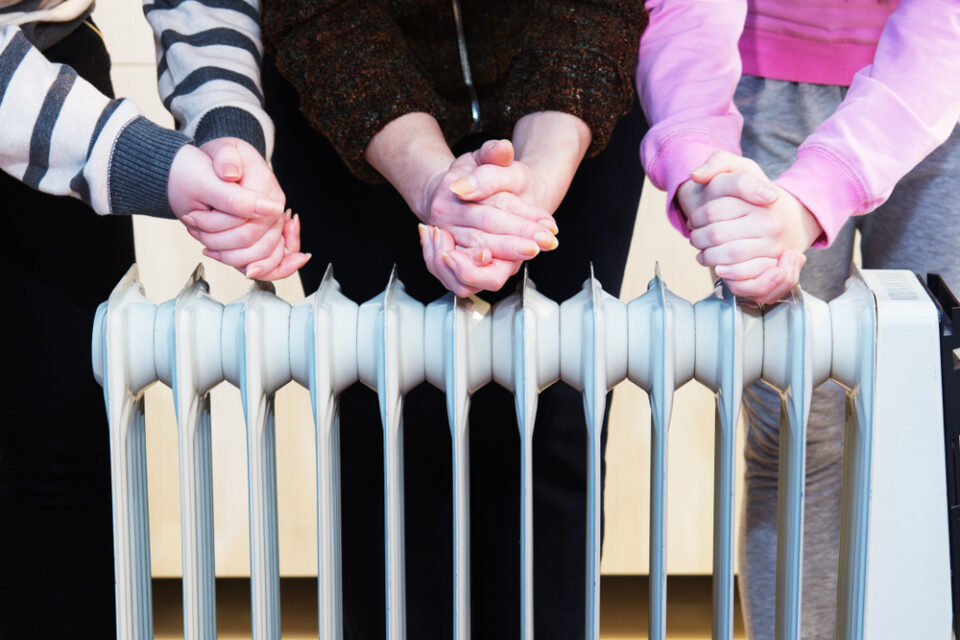 Warming hands over radiator